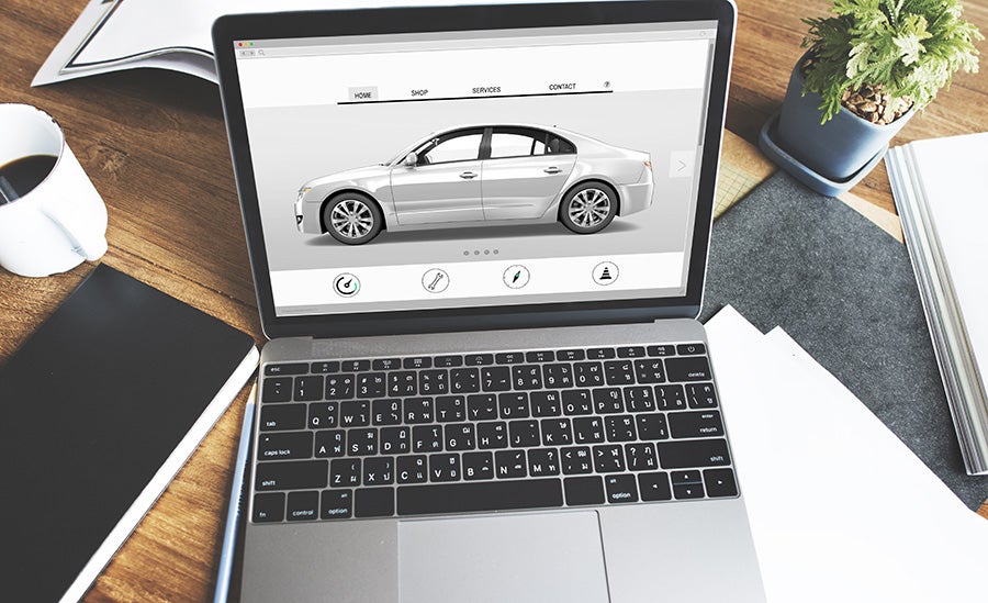 Online vehicle inventory displayed on a laptop for digital car shopping